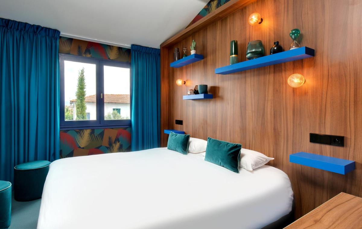 Un ou plusieurs lits dans un hébergement de l'établissement Hôtel Montmorency & Spa