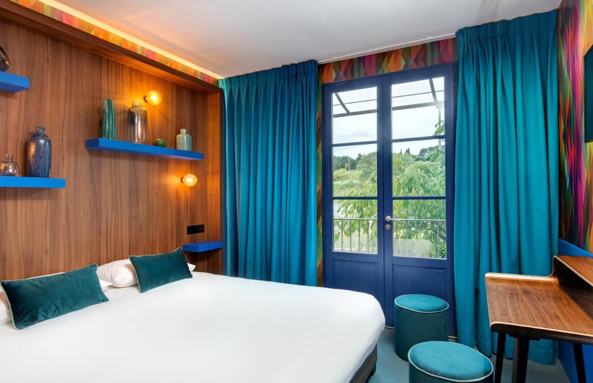 Un ou plusieurs lits dans un hébergement de l'établissement Hôtel Montmorency & Spa