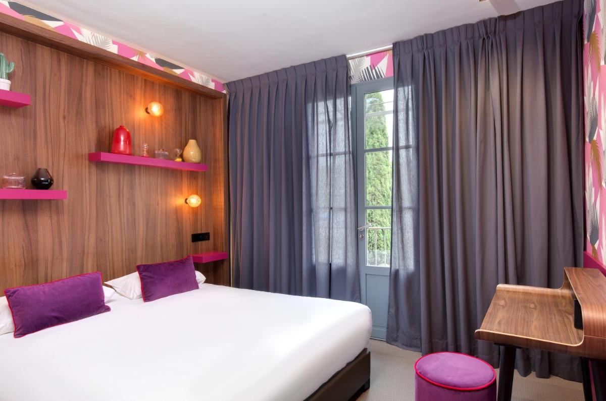 Un ou plusieurs lits dans un hébergement de l'établissement Hôtel Montmorency & Spa