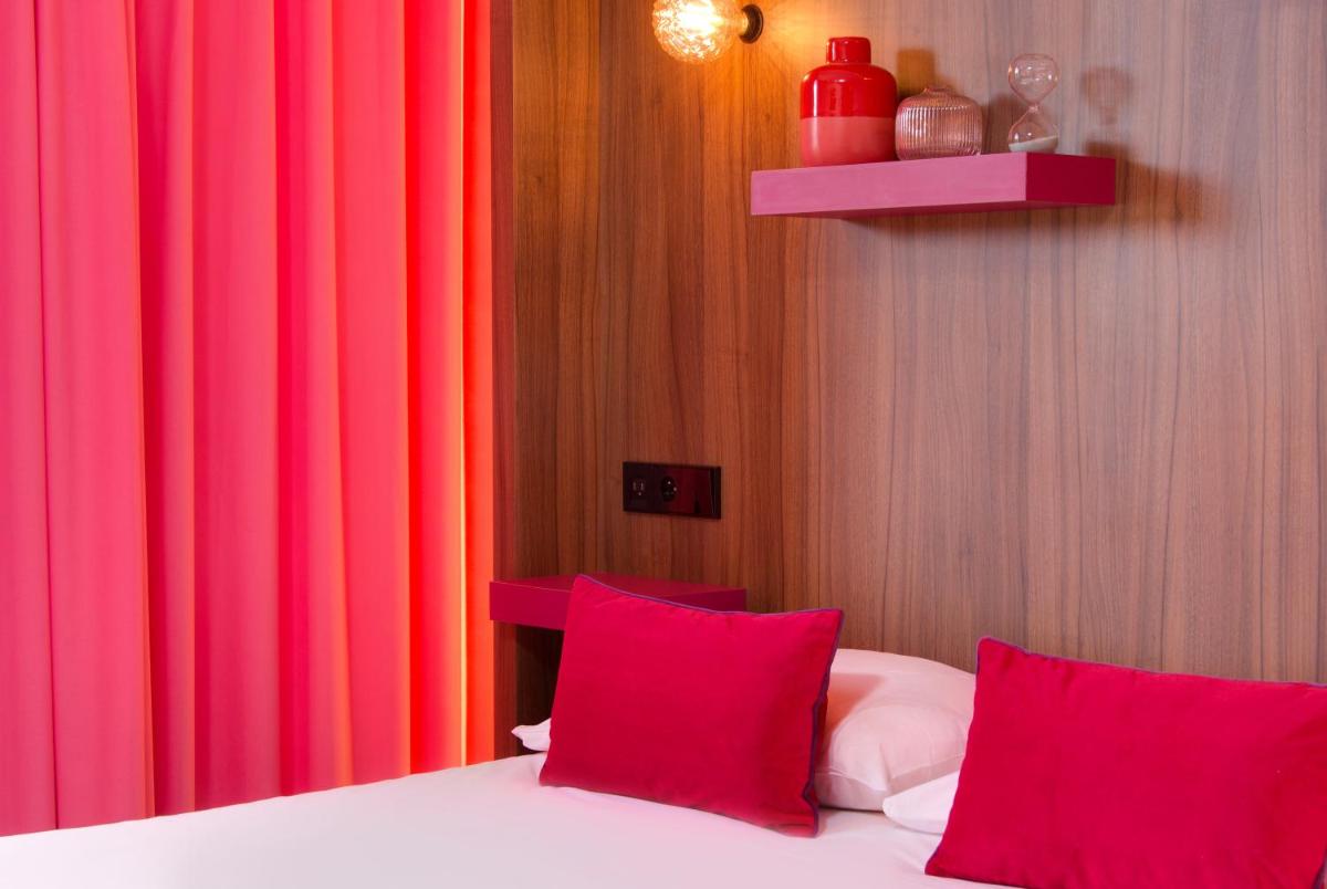 Un ou plusieurs lits dans un hébergement de l'établissement Hôtel Montmorency & Spa