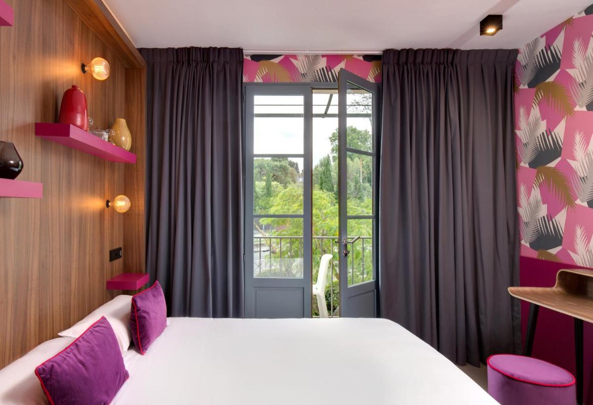Un ou plusieurs lits dans un hébergement de l'établissement Hôtel Montmorency & Spa