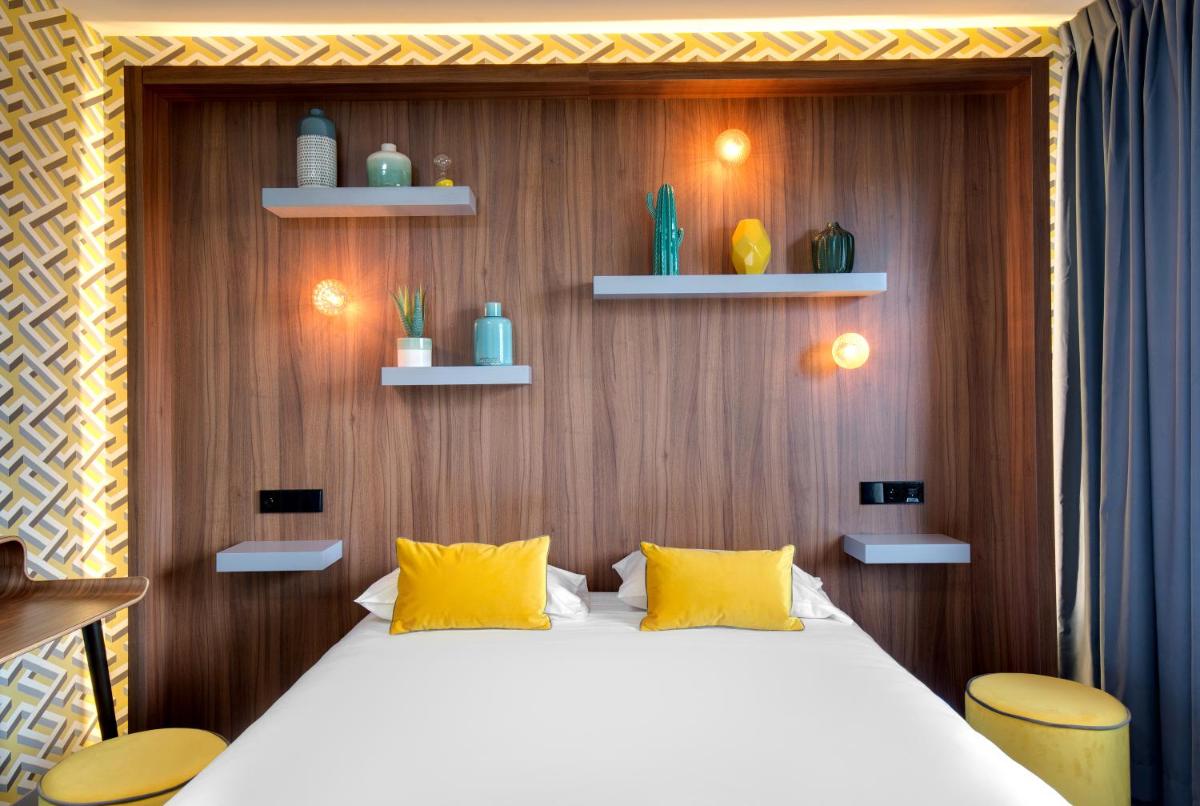 Un ou plusieurs lits dans un hébergement de l'établissement Hôtel Montmorency & Spa