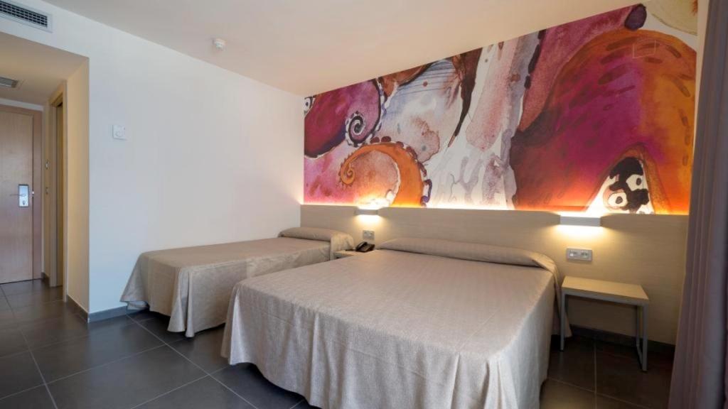 Cama o camas de una habitación en Hotel Riviera