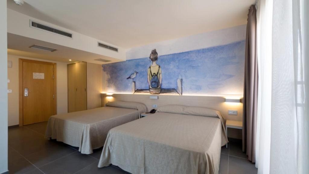 Cama o camas de una habitación en Hotel Riviera