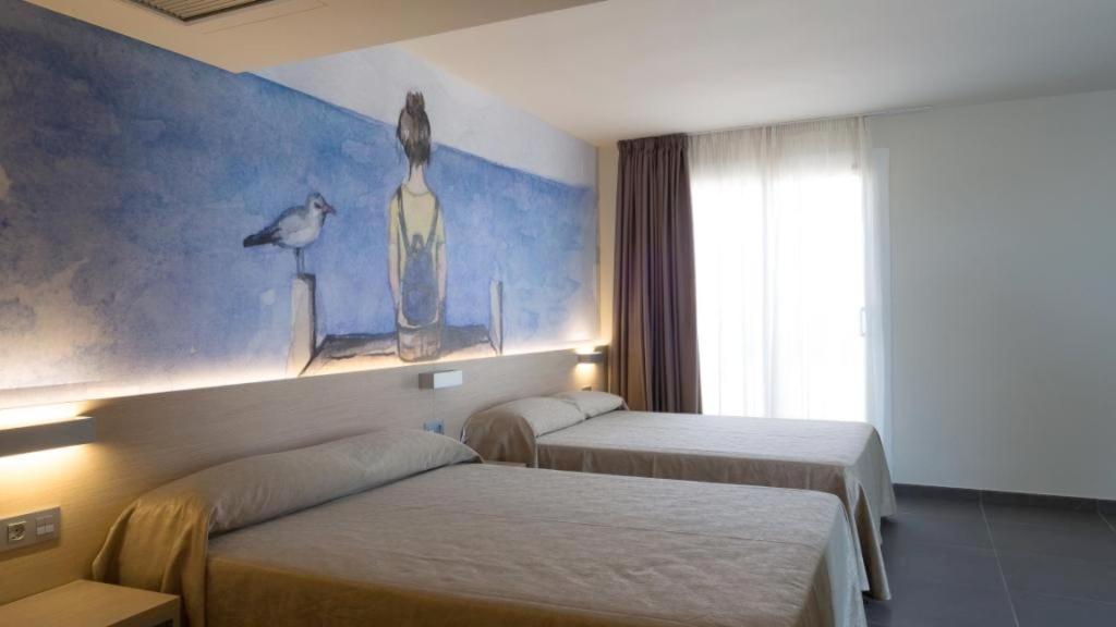 Cama o camas de una habitación en Hotel Riviera