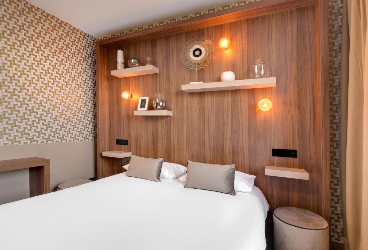 Un ou plusieurs lits dans un hébergement de l'établissement Hôtel Montmorency & Spa
