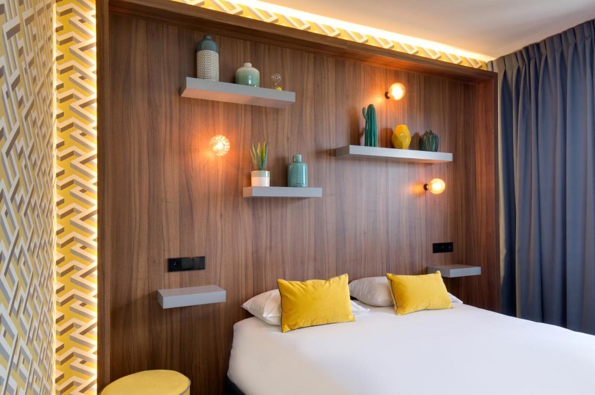 Un ou plusieurs lits dans un hébergement de l'établissement Hôtel Montmorency & Spa