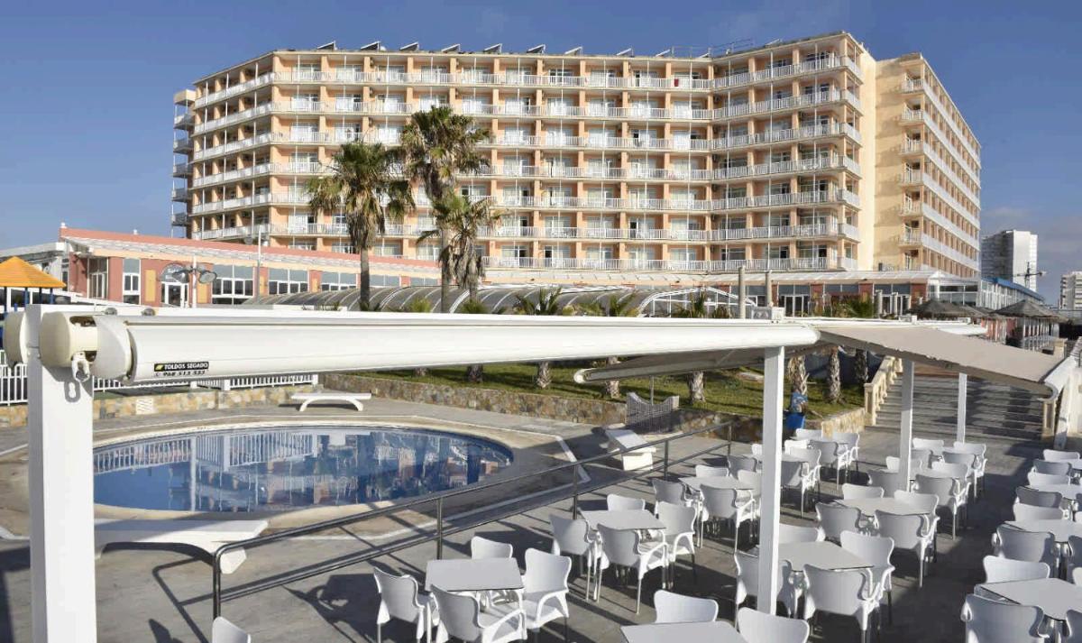 Un hotel con piscina y sillas y un edificio. en Hotel & Spa Entremares, en La Manga del Mar Menor