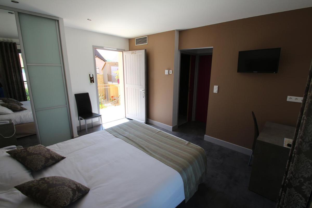 Un ou plusieurs lits dans un hébergement de l'établissement Logis Hotel Archambeau