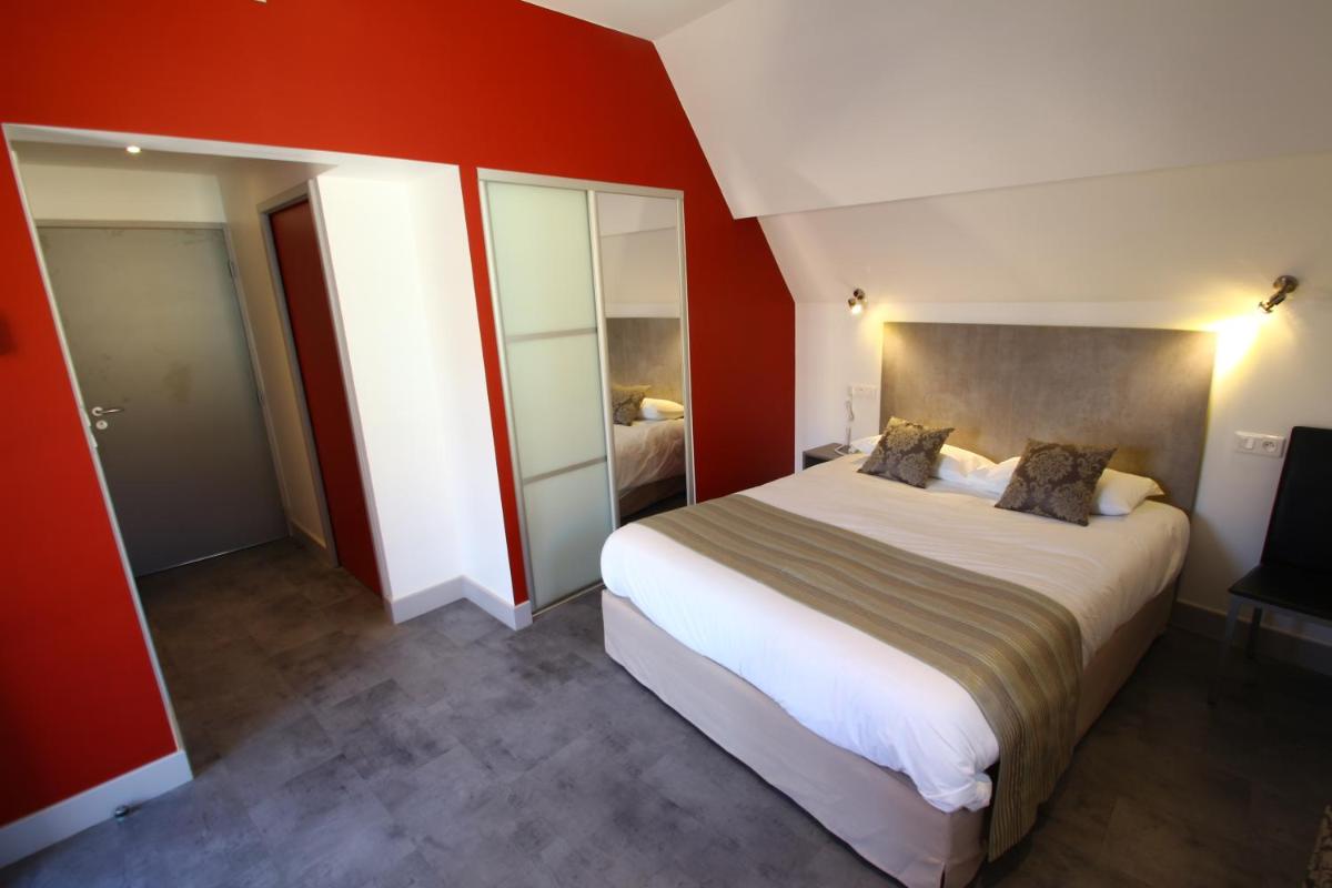 Un ou plusieurs lits dans un hébergement de l'établissement Logis Hotel Archambeau
