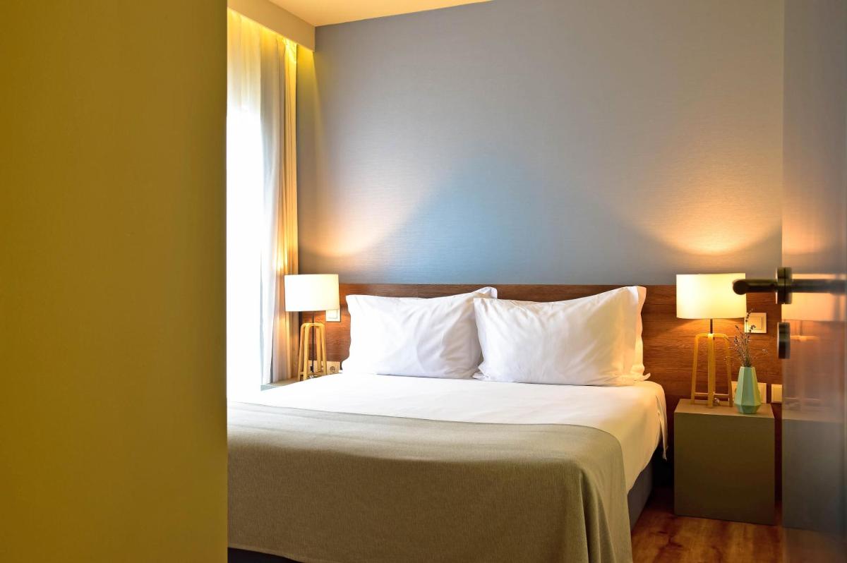 Uma cama ou camas num quarto em The Prime Energize Hotel & SPA - Algarve