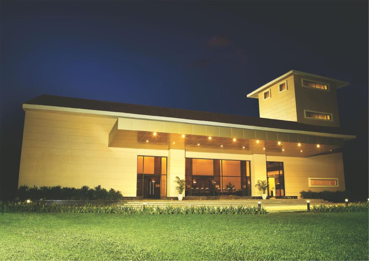 a large building with lights on it at night at The Retreat Hotel & Convention Centre in Mumbai