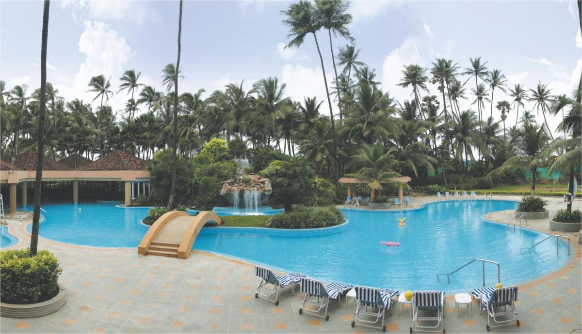 a large swimming pool with a slide in a resort at The Retreat Hotel & Convention Centre in Mumbai