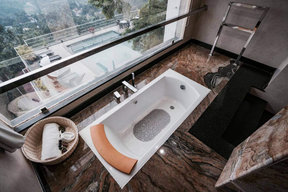 a bathroom with a sink and a large window at The Panoramic Getaway in Munnar