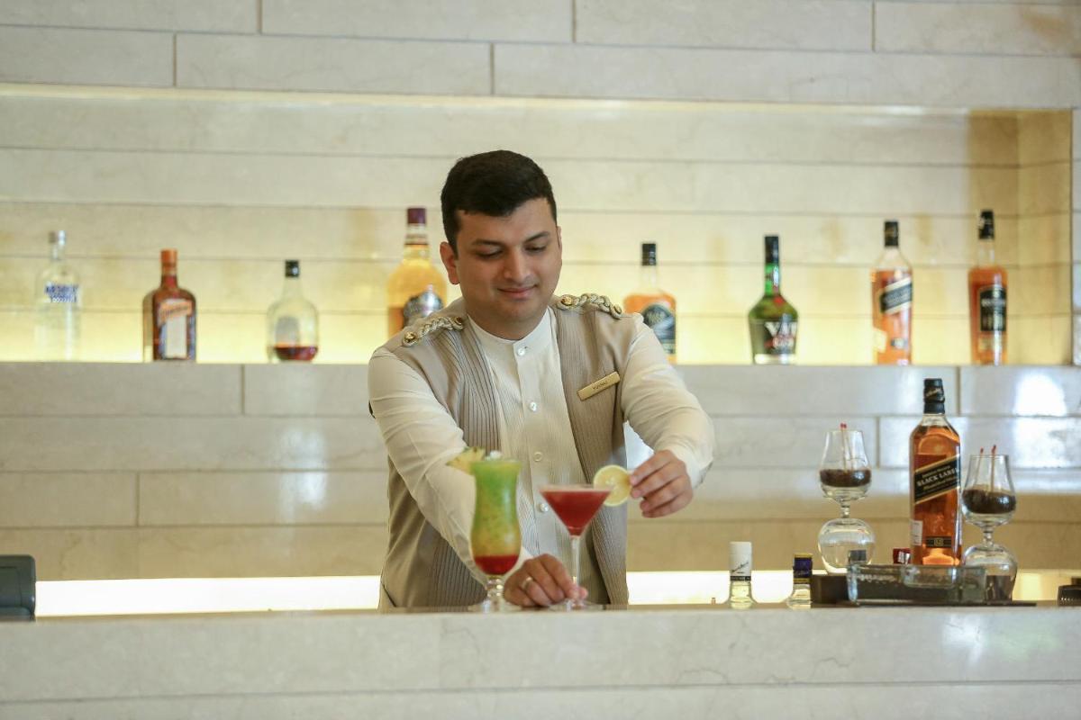 a man standing at a bar preparing a drink at Trident Agra in Agra