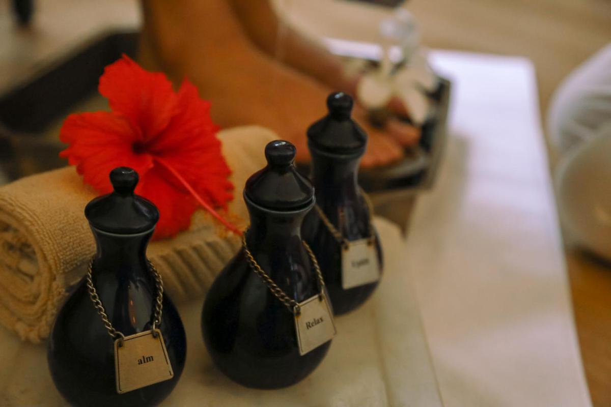 three black bottles with tags on them on a table at Trident Agra in Agra