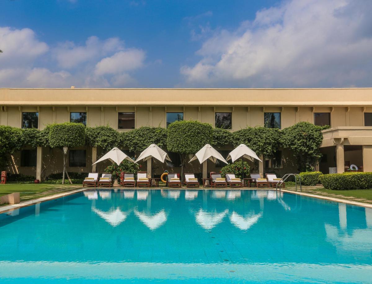 a swimming pool in front of a hotel at Trident Agra in Agra