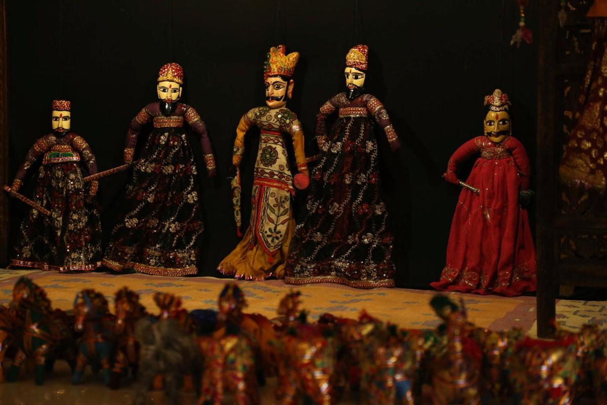 a group of four figurines of people on a stage at Trident Agra in Agra