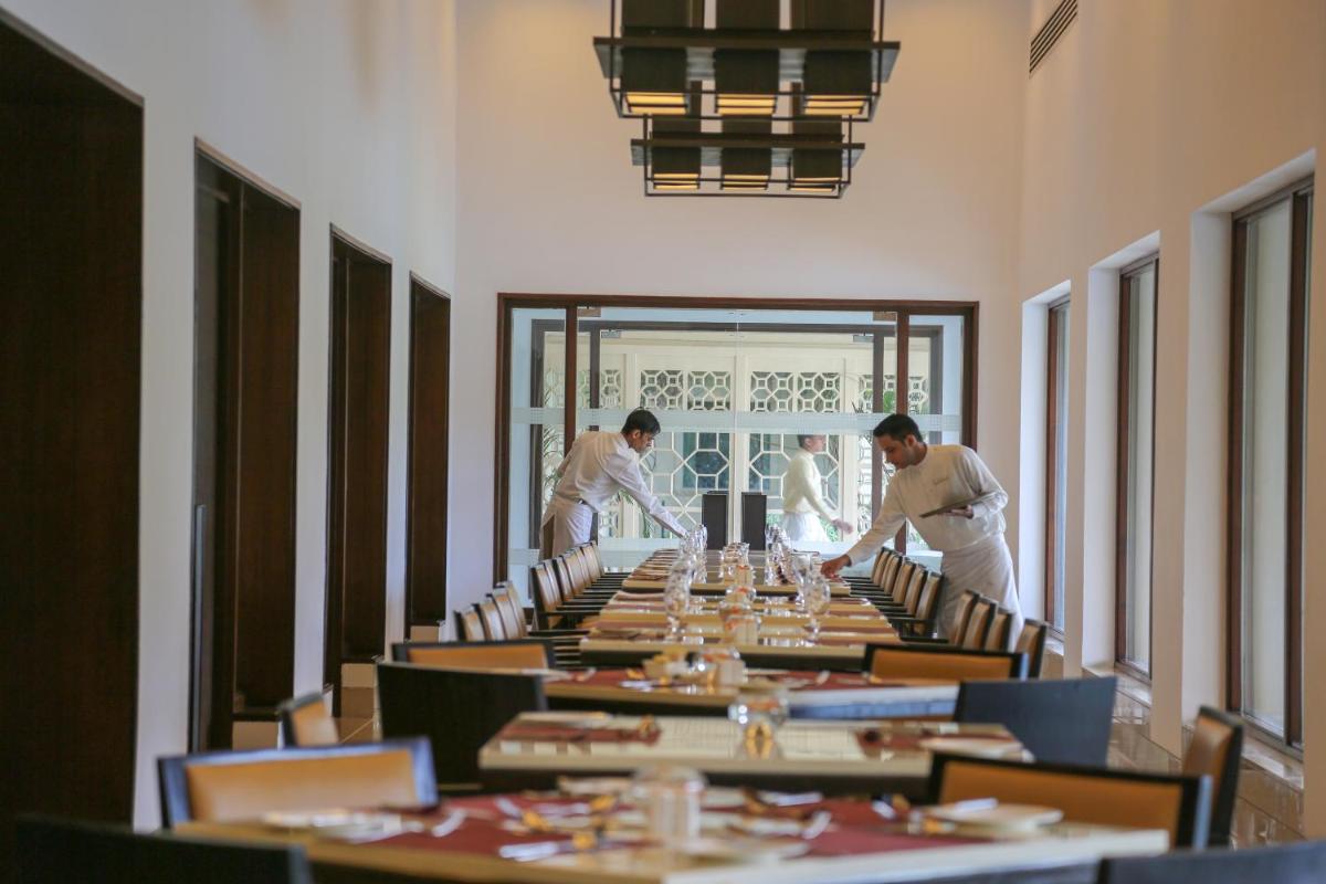 a group of men standing around a long table at Trident Agra in Agra