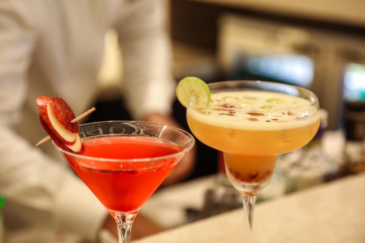 two cocktails sitting on top of a table at Trident Agra in Agra