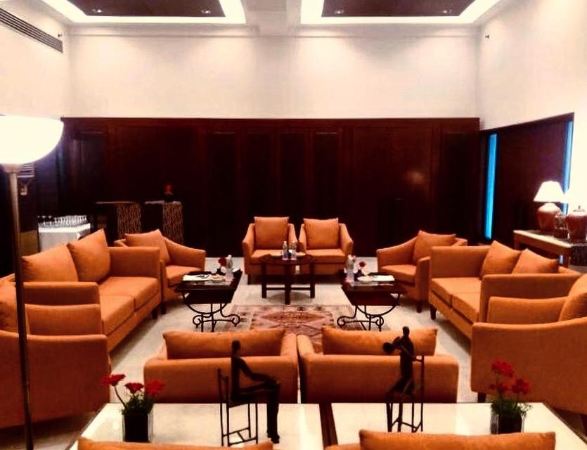 a large room with couches and tables in a lobby at Trident Agra in Agra