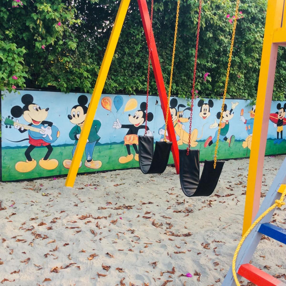 a group of swings at a playground at Trident Agra in Agra