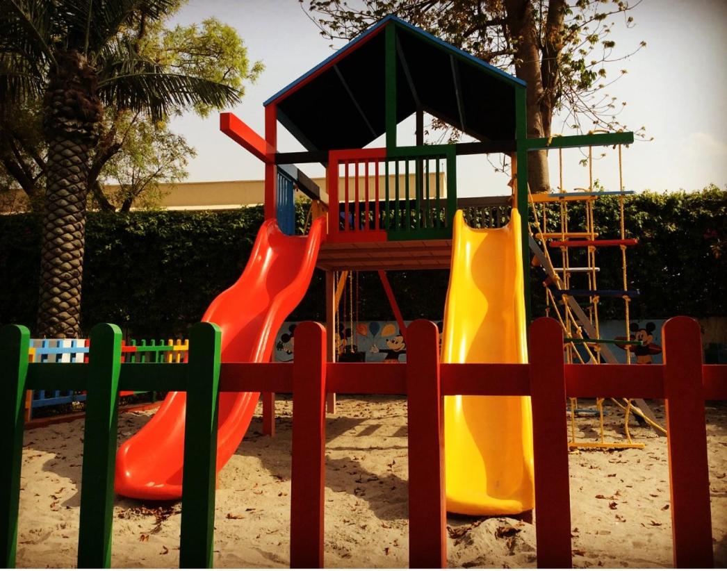 a playground with colorful slides and a play structure at Trident Agra in Agra