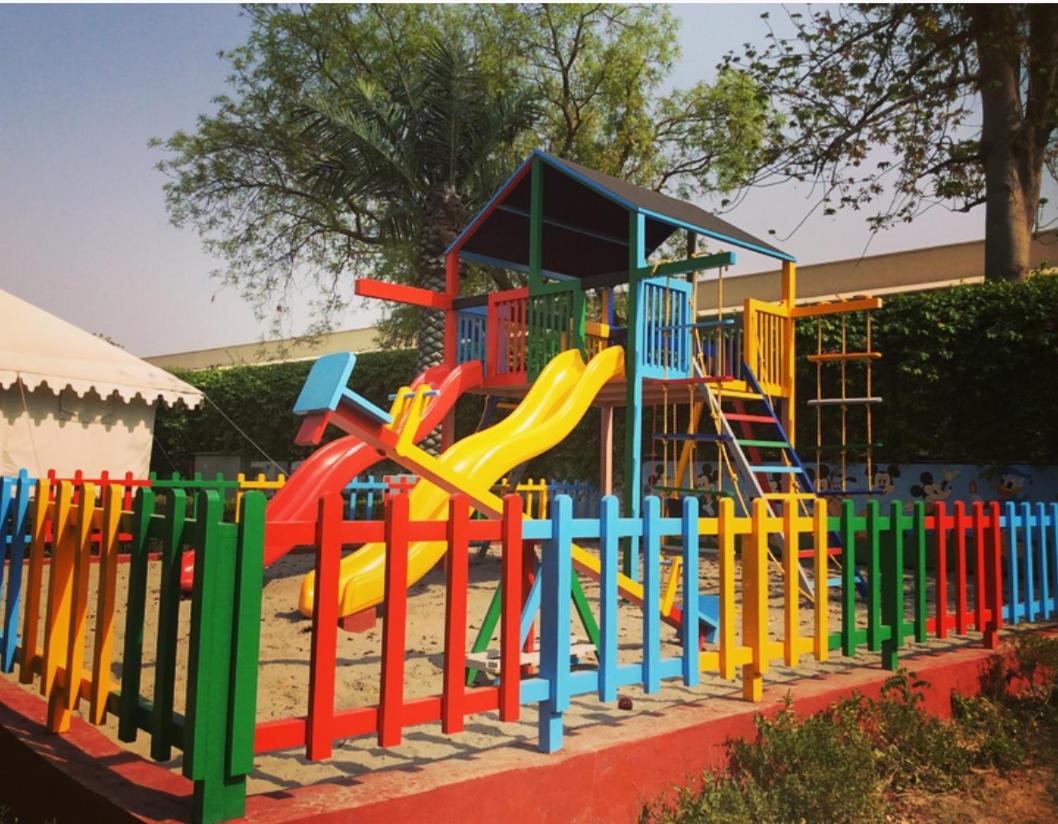 a playground with a slide and a play structure at Trident Agra in Agra