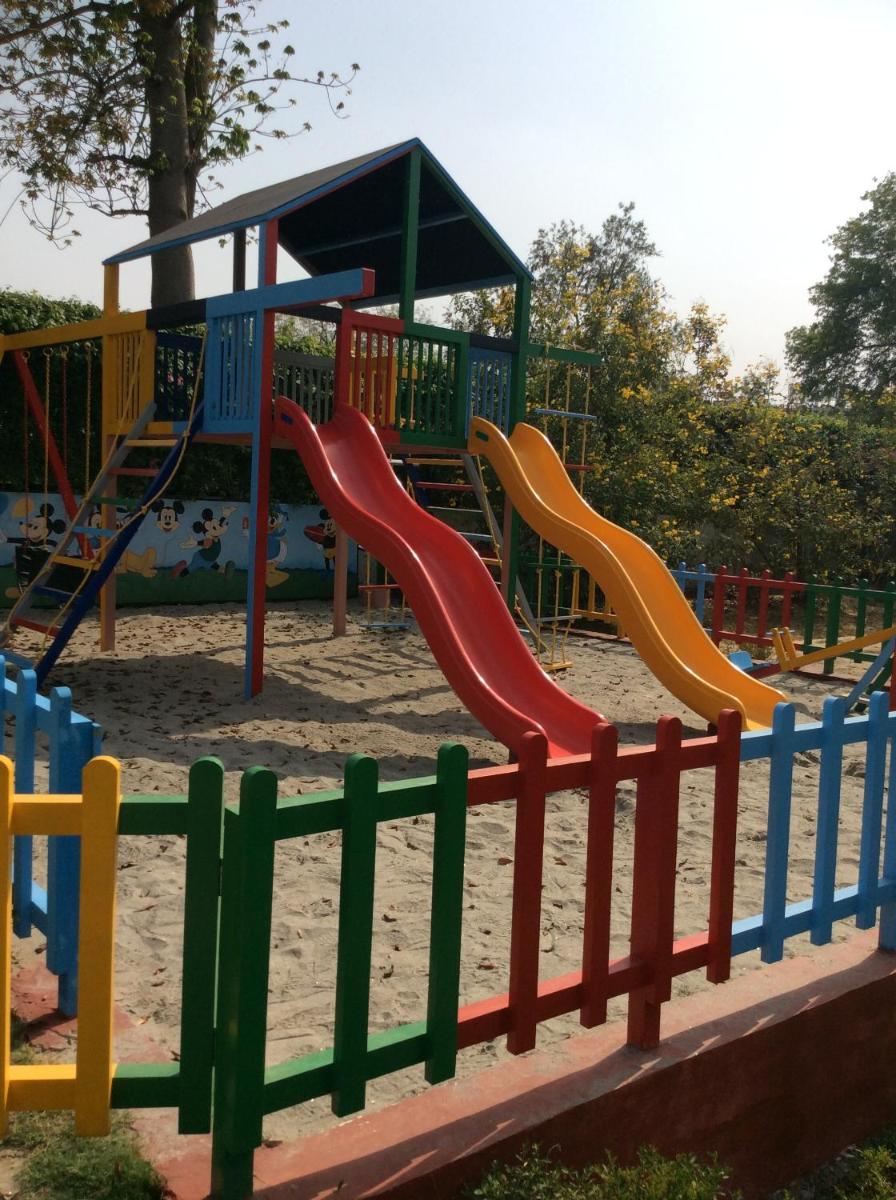 a playground with a slide in the sand at Trident Agra in Agra