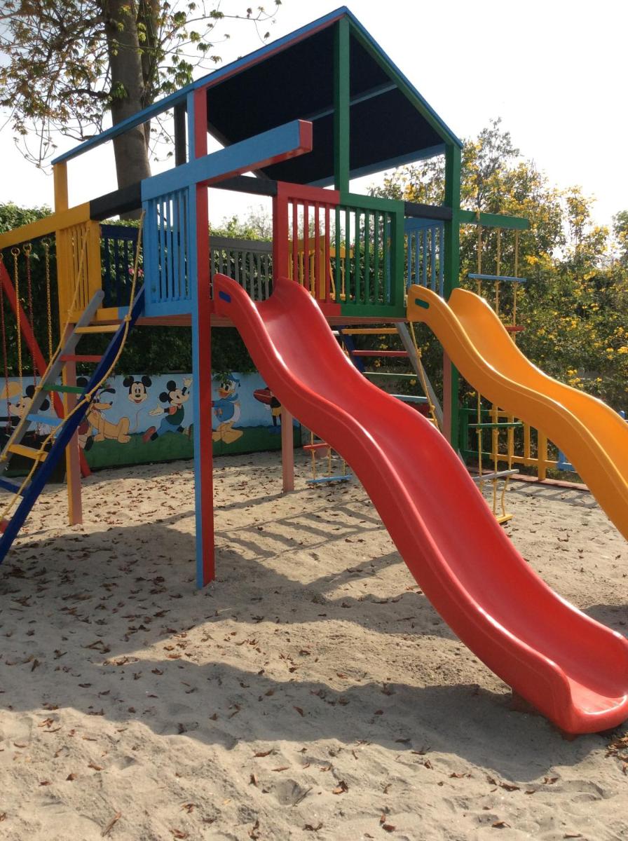 a playground with a slide in the sand at Trident Agra in Agra