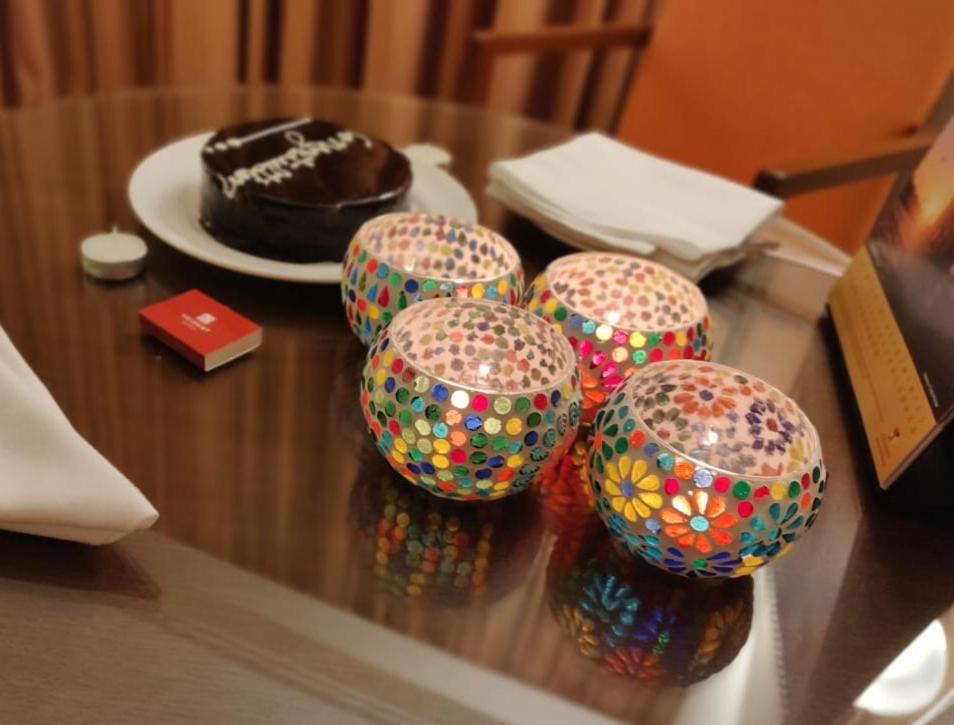 a table with four balls on a table with a chocolate cake at Trident Agra in Agra