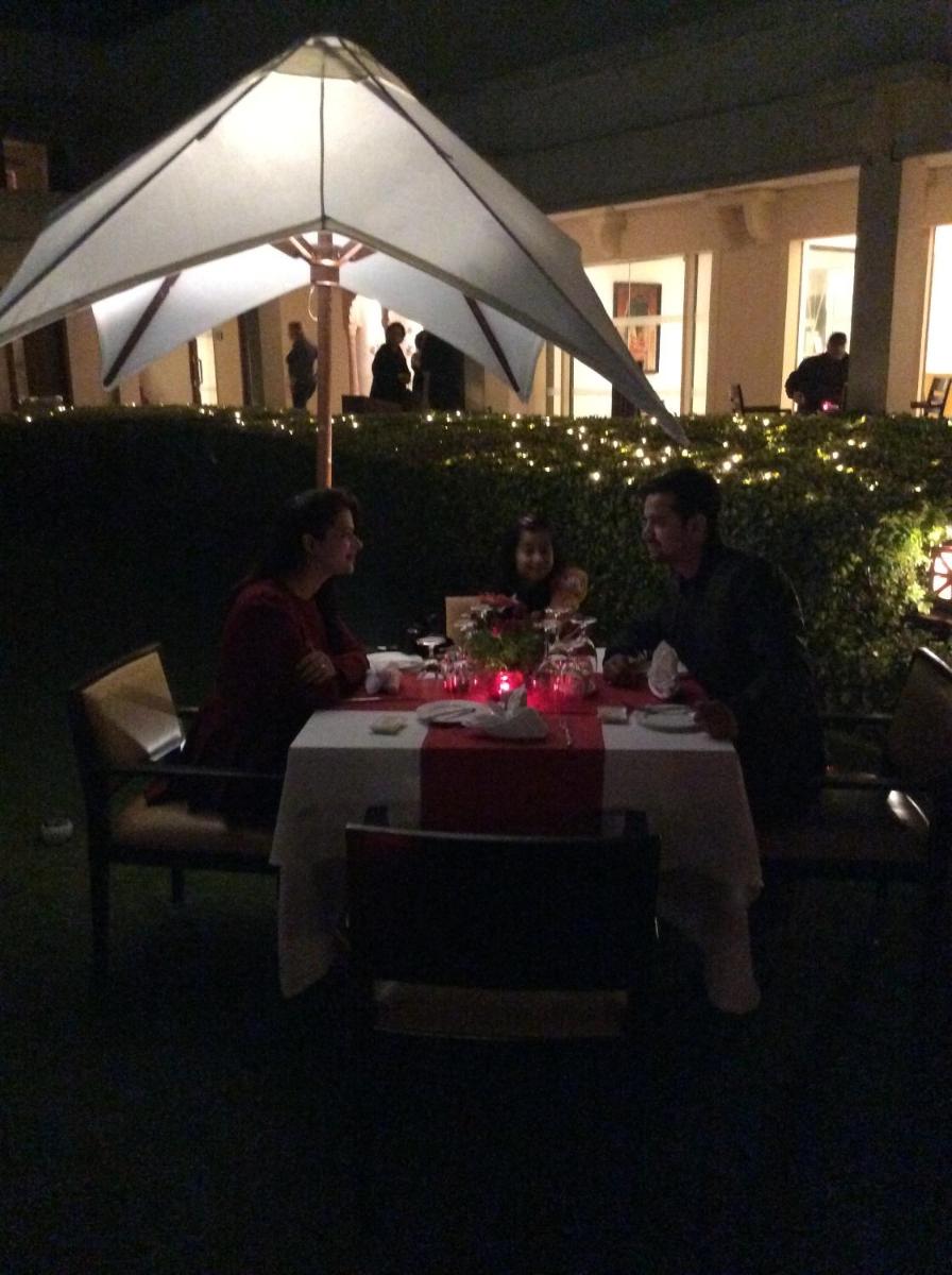 a group of people sitting at a table at night at Trident Agra in Agra