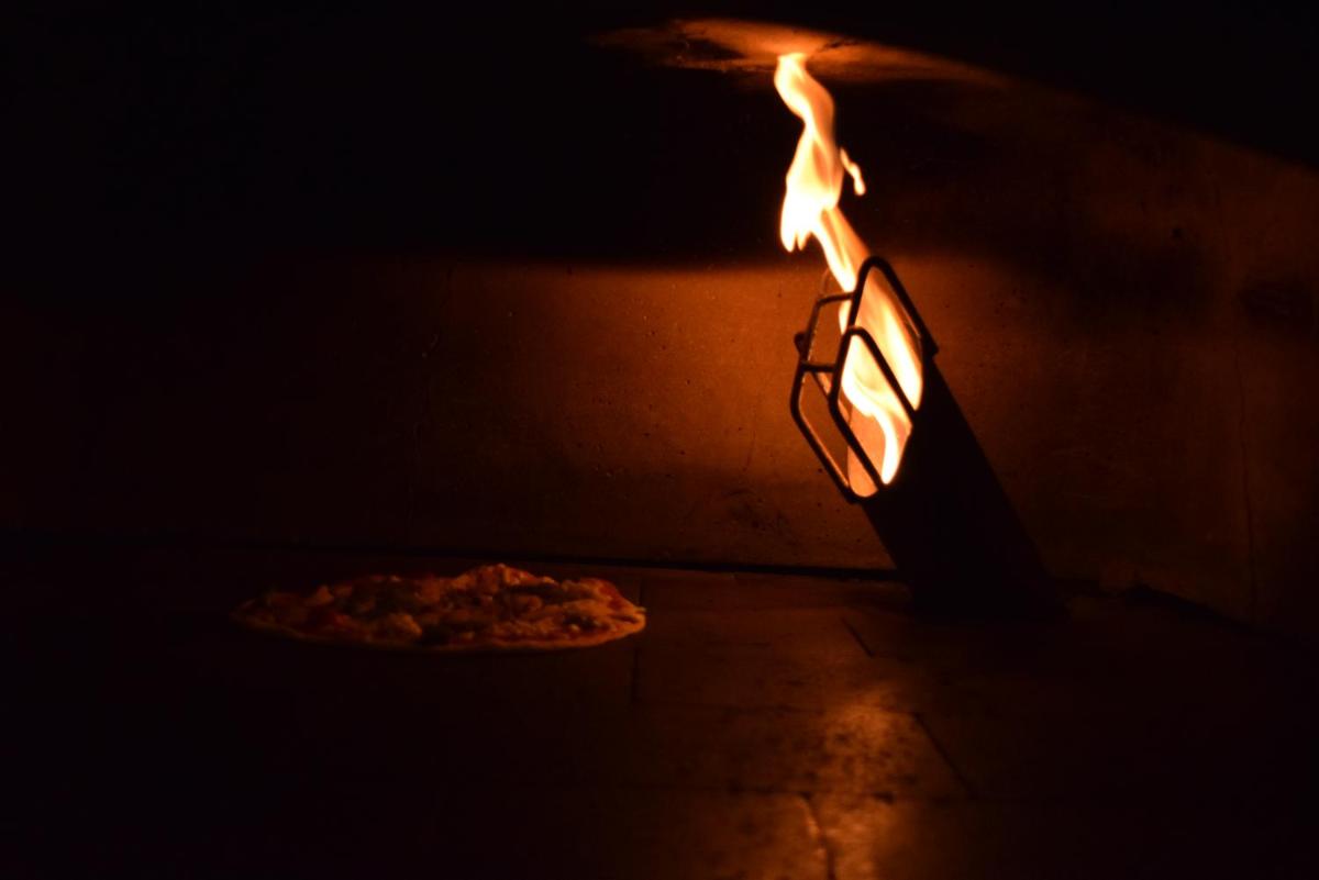 a pizza is being cooked in an oven at Trident Agra in Agra
