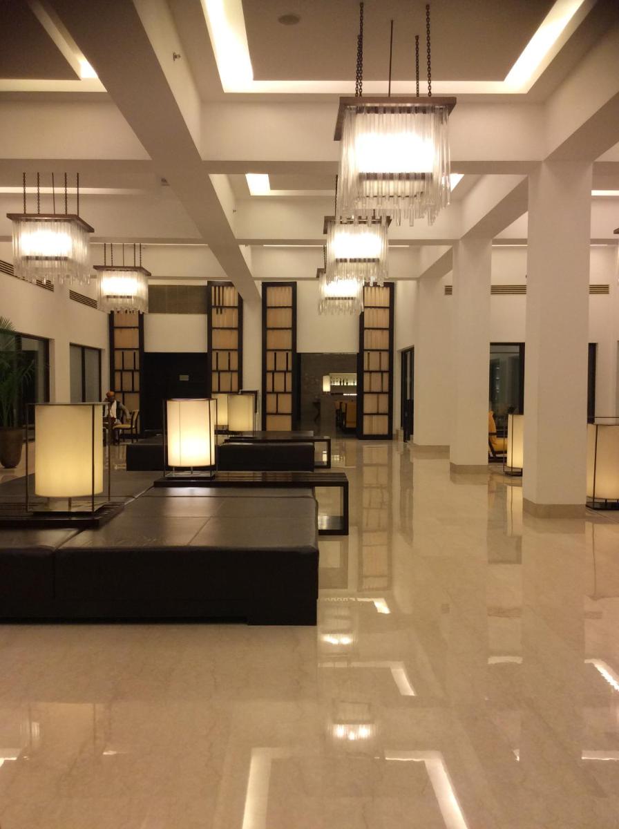a large lobby with chandeliers in a building at Trident Agra in Agra
