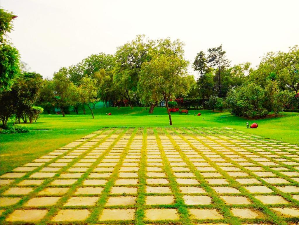 a view of a park with trees and grass at Trident Agra in Agra