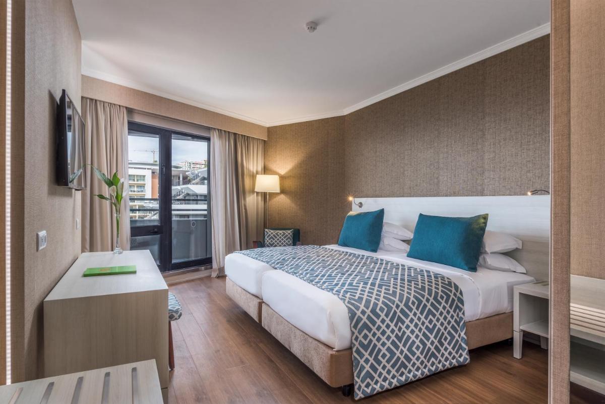 Uma cama ou camas num quarto em Enotel Lido - All Inclusive
