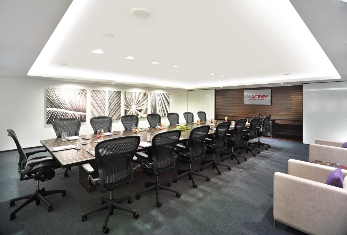 a conference room with a long table and chairs at Vivanta Chennai IT Expressway OMR in Chennai