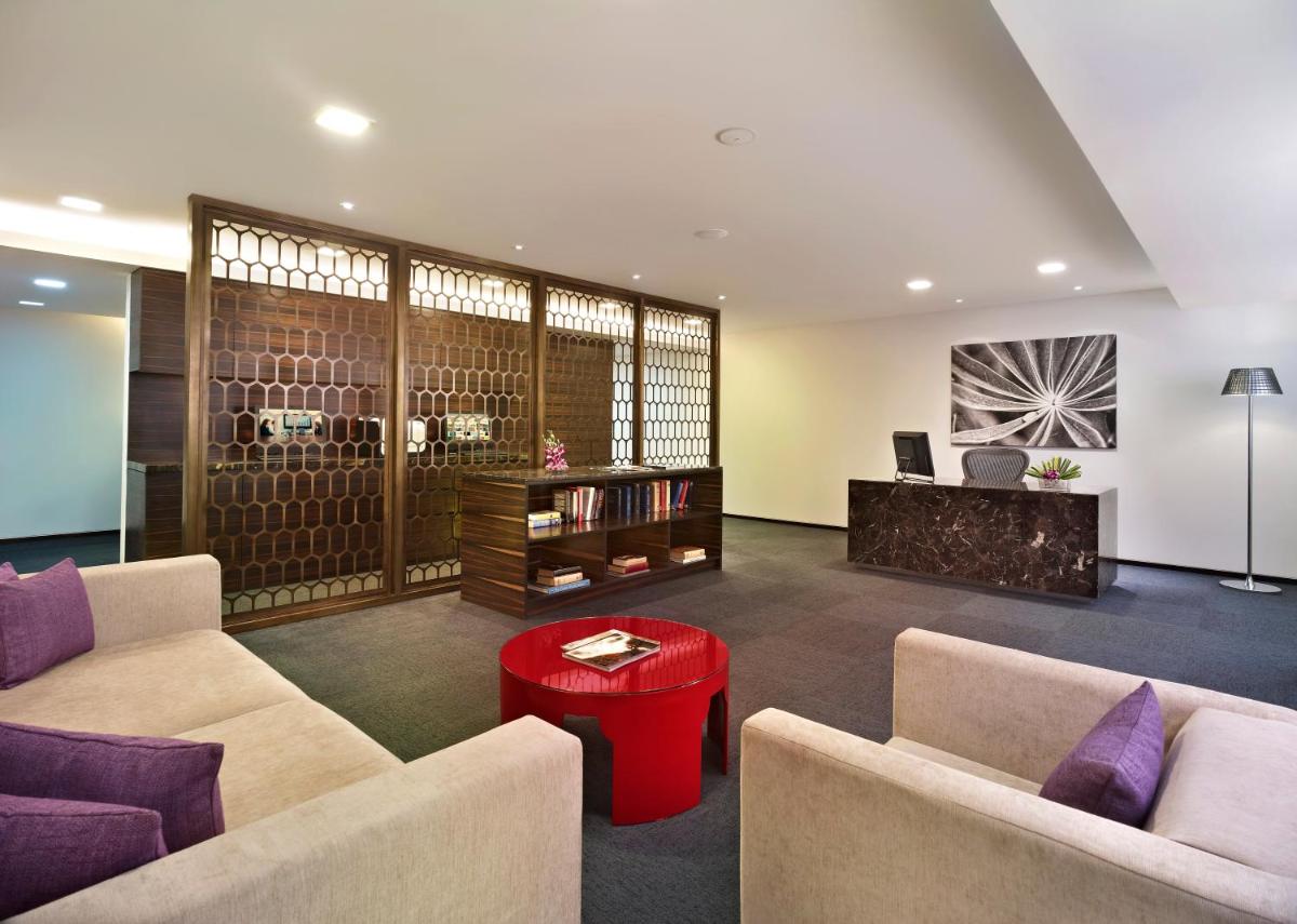 a living room with two couches and a table at Vivanta Chennai IT Expressway OMR in Chennai