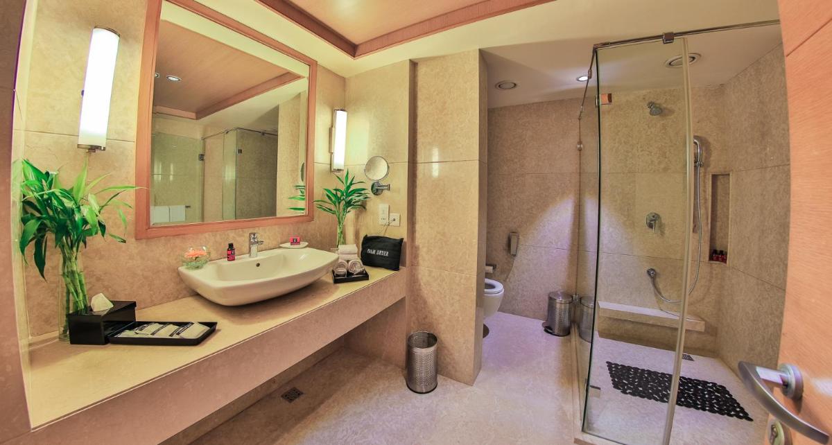 a bathroom with a sink and a shower at The Lalit Chandigarh in Chandīgarh