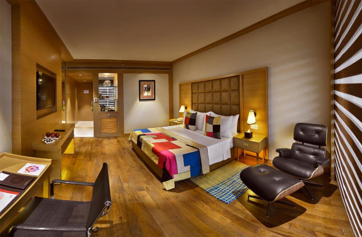 a hotel room with a bed and a desk at The Lalit Chandigarh in Chandīgarh