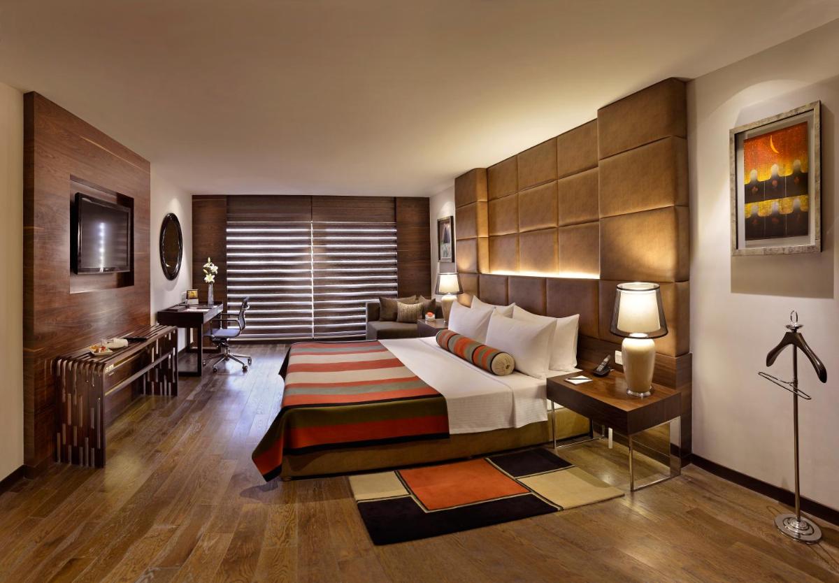 a hotel room with a bed and a desk at The Lalit Chandigarh in Chandīgarh