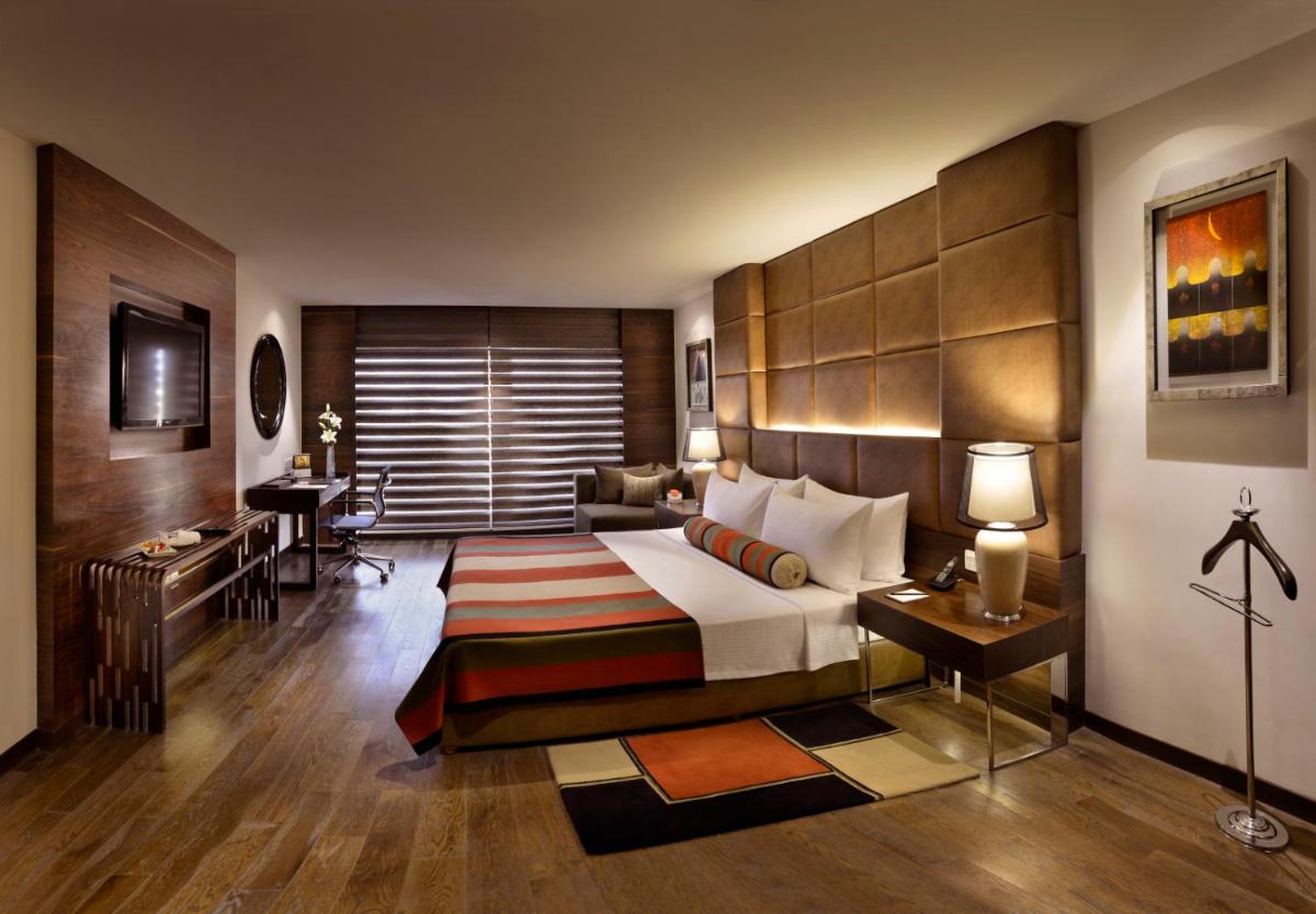 a hotel room with a bed and a desk at The Lalit Chandigarh in Chandīgarh