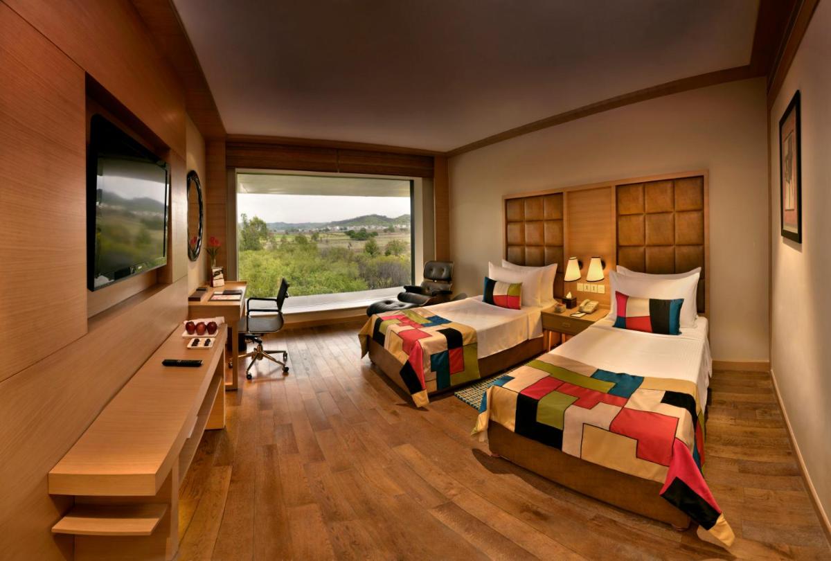 a hotel room with two beds and a window at The Lalit Chandigarh in Chandīgarh