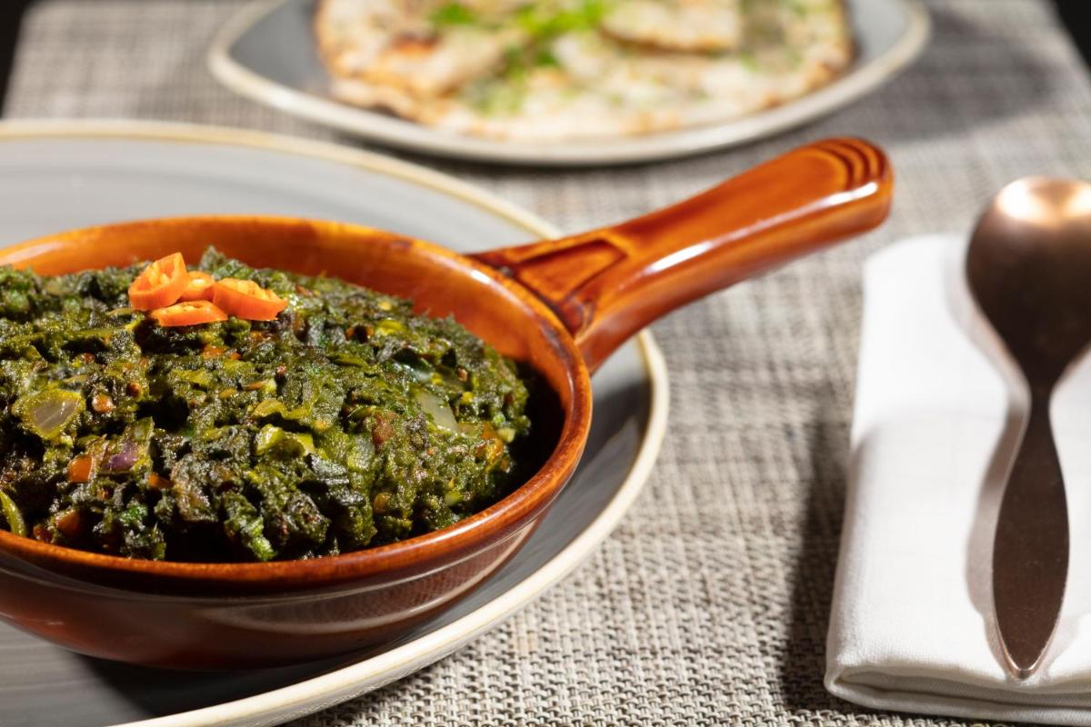 a bowl of food on a table with a plate of food at Radisson Blu Atria Bengaluru in Bengaluru a bowl of food on a table with a plate of food at Radisson Blu Atria Bengaluru in Bengaluru
