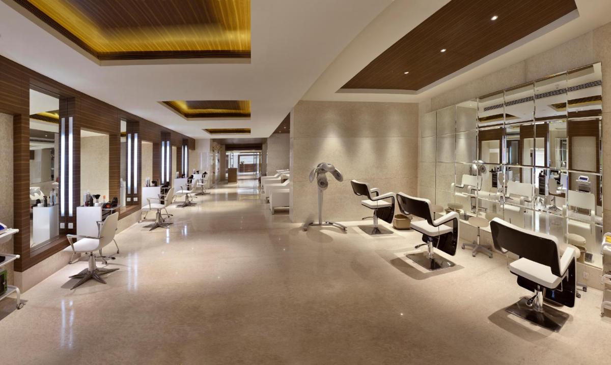 a hair salon with a row of chairs and a hair salon at The Lalit Chandigarh in Chandīgarh