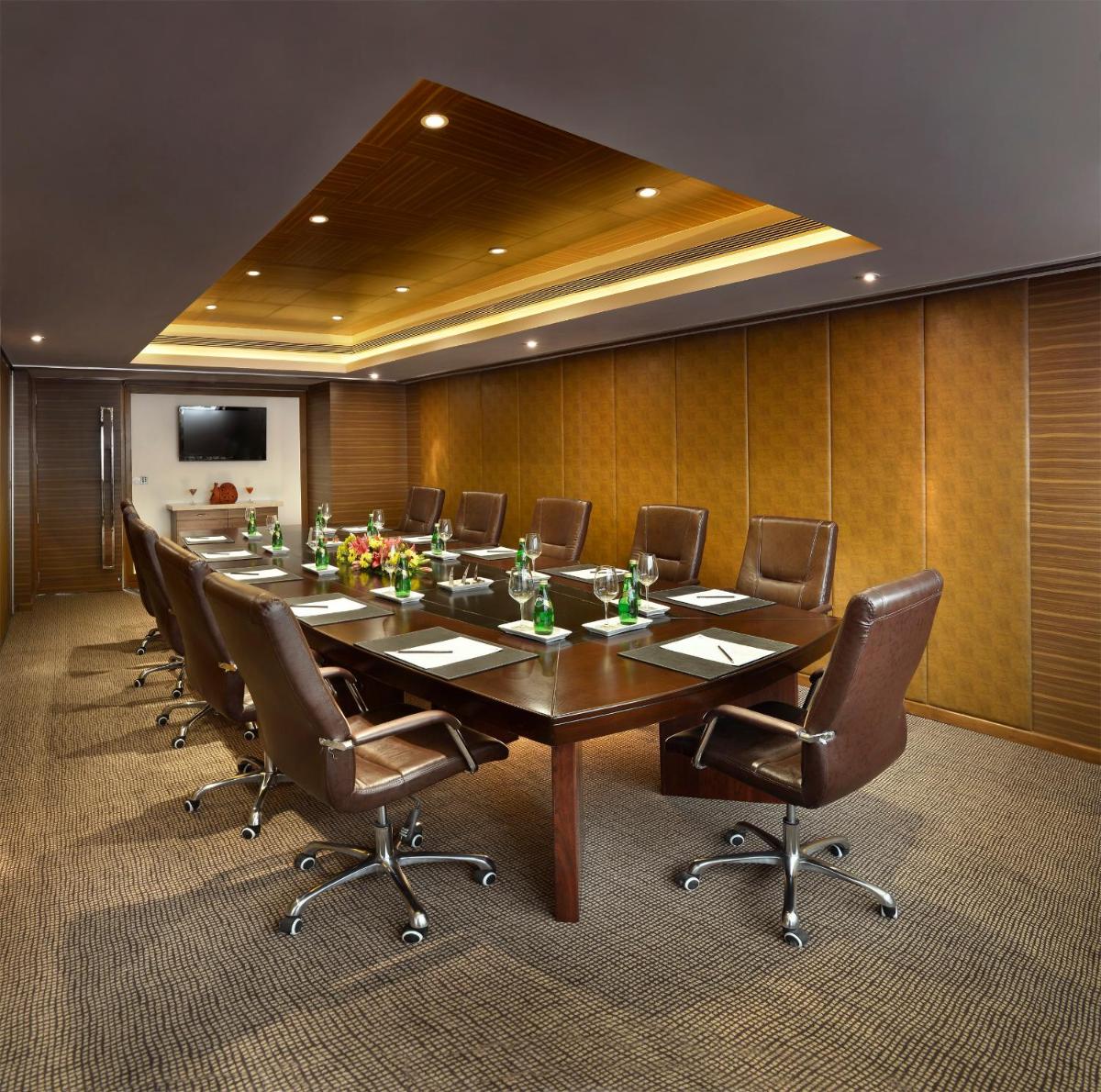 a large conference room with a long table and chairs at The Lalit Chandigarh in Chandīgarh