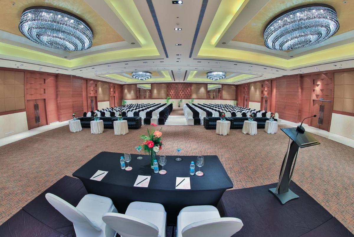 a banquet hall with tables and chairs in a room at The Lalit Chandigarh in Chandīgarh