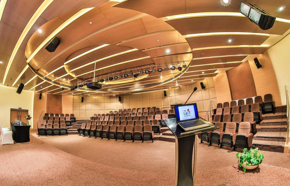 an empty auditorium with a laptop on a podium in the middle at The Lalit Chandigarh in Chandīgarh