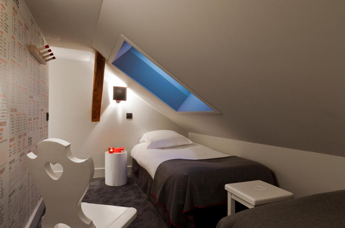 Un ou plusieurs lits dans un hébergement de l'établissement Le Faucigny - Hotel de Charme & SPA