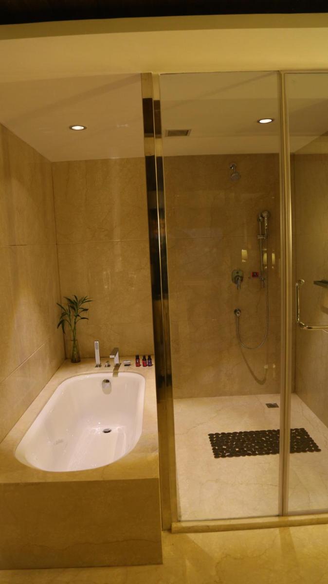 a bathroom with a sink and a shower at The Lalit Chandigarh in Chandīgarh